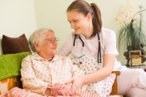 Assisted living medical staff helping a senior woman
