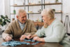 Older adults playing puzzles is one of the activities at Bel Air Assisted Living with integrated memory care