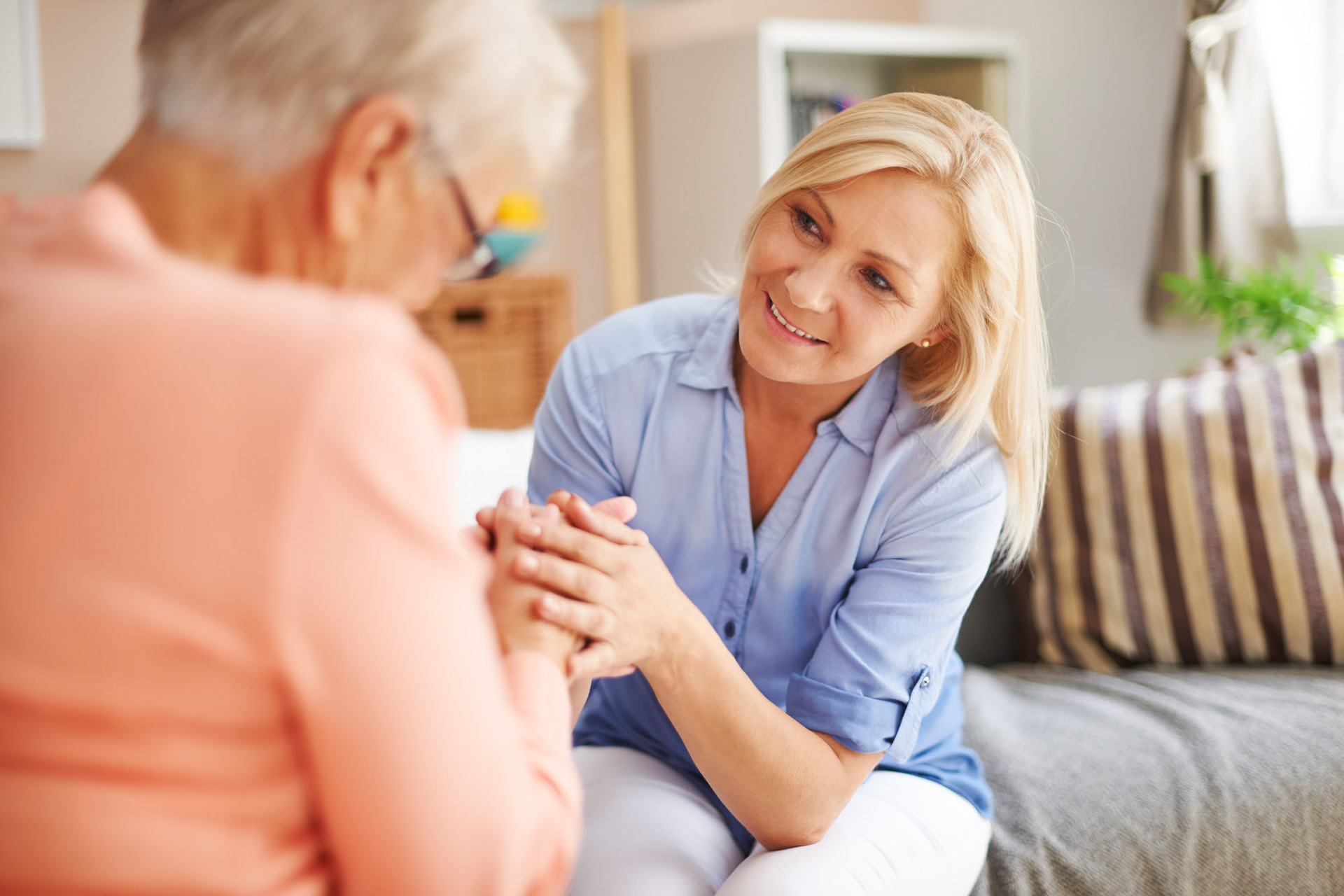 Woman explaining to her mother the symptoms and signs it's time for memory care