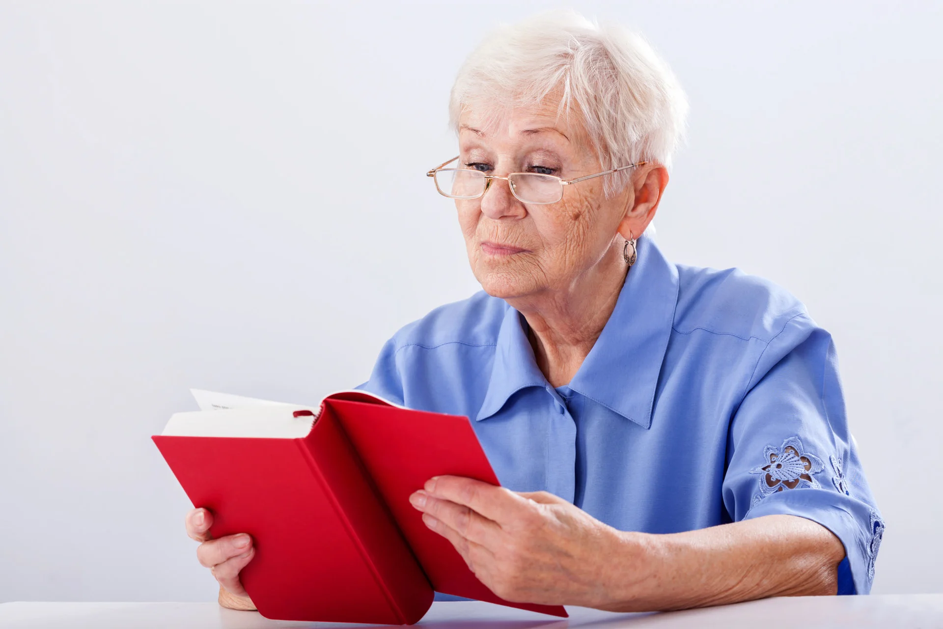 Assisted living facility near Nottingham, MD - Older adult reading a book