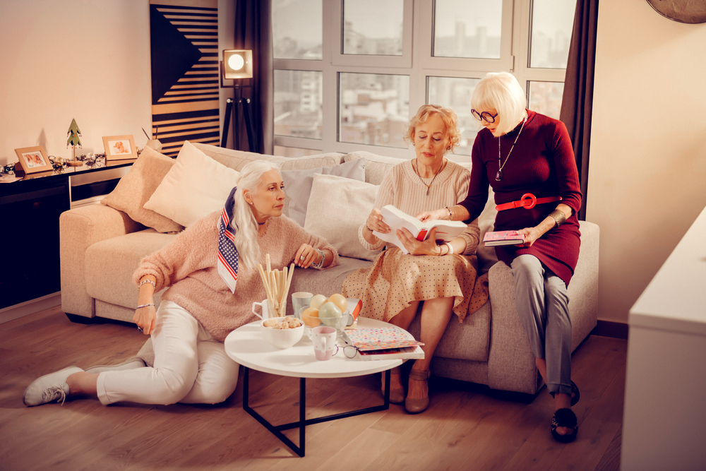 One benefits of senior living is to have a great community to live with - Senior women discussing fiction books