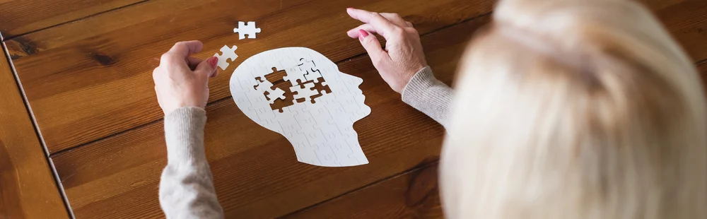 Caregiver and family discussing memory loss solutions while reducing caregiver stress in a compassionate memory care community