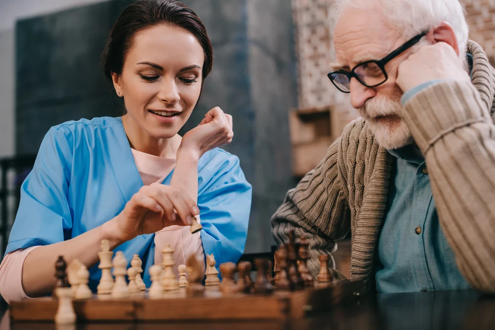 Compassionate caregivers providing personal care and daily engagement activities for memory care residents living with cognitive impairment